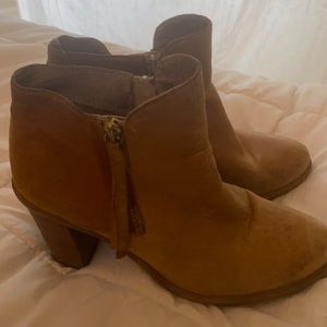 Tan heeled boots with fringe zippers